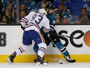San Jose Sharks left wing Mikkel Boedker (89) battles for the puck against Edmonton Oilers defenseman Matthew Benning (83) during the first period in Game 6 of a first-round NHL hockey playoff series Saturday, April 22, 2017, in San Jose, Calif. (AP Photo/Tony Avelar)