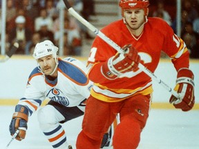 Edmonton Oilers forward Glenn Anderson, left, and Calgary Flames forward Collin Patterson during Game 1 of the Smythe Division final on April 18, 1986, at Edmonton's Northlands Coliseum.