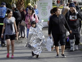 A boy is wrapped in foil after being rescued from a flooded neighborhood Tuesday, Feb. 21, 2017, in San Jose , Calif. Rains saturated once-drought stricken California but created chaos for residents hit hard by the storms.