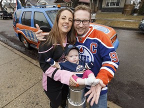 Allen Southerton, Michelle Borkent and six-month-old Abigail pose with their tricked out Edmonton Oilers fan ride outside their home on Thursday, April 13, 2017. The vehicle was kitted out and painted for the playoffs by a group of friends who are avid Oilers fans.