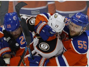 Anaheim Ducks forward Ryan Kesler is roughed up by Edmonton Oilers Leon Draisaitl, left, and Mark Letestu in Game 3 of their second-round playoff series in Edmonton on April 30, 2017. (Larry Wong)