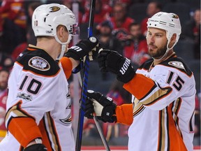 CALGARY, AB - APRIL 17: Ryan Getzlaf #15 (R) congratulates Corey Perry #10 (L) of the Anaheim Ducks after Perry scored the overtime game winner against the Calgary Flames in Game Three of the Western Conference First Round during the 2017 NHL Stanley Cup Playoffs at Scotiabank Saddledome on April 17, 2017 in Calgary, Alberta, Canada.