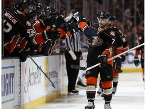 Anaheim Ducks left wing Andrew Cogliano high-fives his teammates after scoring a goal during the third period of an NHL hockey game against the New York Rangers, Sunday, March 26, 2017, in Anaheim, Calif. The Ducks won 6-3.