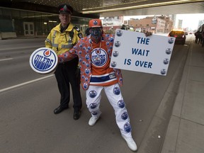 Edmonton Oilers fan Blair Gladue poses for a photo with EPS Const. James McLeod near Rogers Place before Game 1 of the NHL Stanley Cup playoff contest between the Edmonton Oilers and San Jose Sharks on Wednesday, April 12, 2017 in Edmonton.
