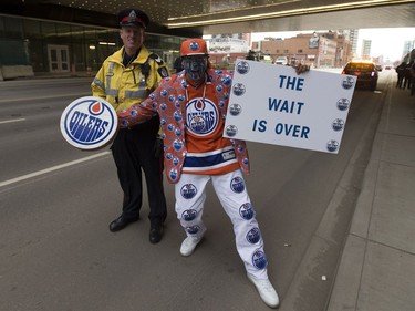 Edmonton Oilers fan Blair Gladue poses for a photo with EPS Const. James McLeod near Rogers Place before Game 1 of the NHL Stanley Cup playoff contest between the Edmonton Oilers and San Jose Sharks on Wednesday, April 12, 2017 in Edmonton.