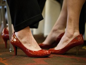 Brian Lindgren, left, sports a pair of ladies shoes along with his wife, Kim Doring-Lindgren, during the Red Shoe Gala at the Doubletree in Edmonton on Saturday, April 22, 2017.