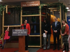Children's Service Minister Danielle Larivee speaks at a news conference in northeast Edmonton on April 20, 2016, as Nia Hughes, 6, plays in the jungle gym behind her.