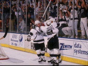 Chris Kontos, Wayne Gretzky and Steve Kasper of the Los Angeles Kings celebrate after scoring a goal in 1990 at the Great Western Forum in Inglewood, Calif.