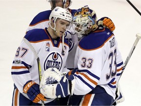 Edmonton Oilers' Connor McDavid (97) celebrates with goalie Cam Talbot (33) after a 1-0 win over the San Jose Sharks during Game 3 of a first-round NHL hockey playoff series Sunday, April 16, 2017, in San Jose, Calif.