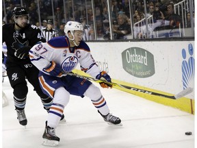 Edmonton Oilers' Connor McDavid (97) is defended by San Jose Sharks' Marc-Edouard Vlasic (44) during the first period of an NHL hockey game Thursday, April 6, 2017, in San Jose, Calif.