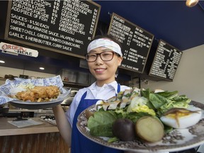 Jay Wuh holds an order of the haddock fish and chips and salad nicoise at Grandin Fish 'n' Chips, 9902 109 St., in Edmonton on Wednesday, April 19, 2017.