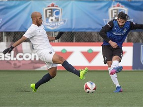 FC Edmonton midfielder Nico Di Biase looks for the ball against Jacksonville Armada midfielder J. C. Banks  at Clarke Park, in Edmonton April 8, 2017.