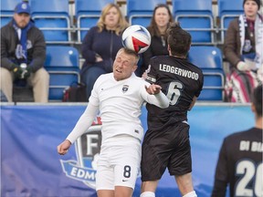 Jacksonville Armada's Jake Black heads the ball against FC Edmonton captain Nik Ledgerwood at Clarke Park in Edmonton on April 8, 2017. (Amber Bracken)