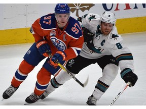 Captains Connor McDavid of the Edmonton Oilers, left, and Joe Pavelski of the San Jose Sharks battle for the puck on April 12, 2017, during Game 1 of their first-round NHL playoff series at Rogers Place in Edmonton.