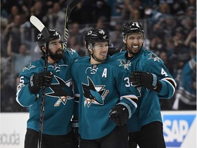 Logan Couture #39, David Schlemko #5 and Brenden Dillon #4 of the San Jose Sharks celebrate after Couture scored a goal against the Edmonton Oilers during the second period in Game Four of the Western Conference First Round during the 2017 NHL Stanley Cup Playoffs at SAP Center on April 18, 2017 in San Jose, California.