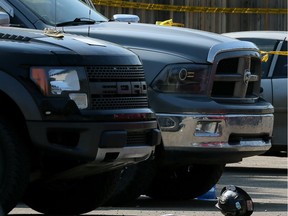 A hardhat sits on the ground next to two pickups after laid-off worker William Hawkins shot construction supervisor Jason Johnstone in west Edmonton in 2015.