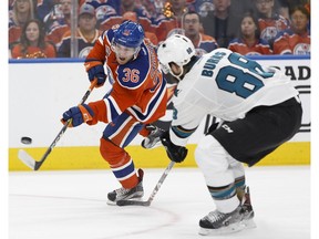 Edmonton Oilers'Drake Caggiula shoots past San Jose's Brent Burns during their opening game of the Stanley Cup playoffs at Rogers Place in Edmonton on Wednesday, April 12, 2017. (Ian Kucerak)