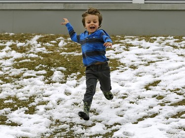 Elliott Viminitz, 4, runs down a hill outside the Muttart Conservatory on Monday April 17, 2017 after snowfall in Edmonton.