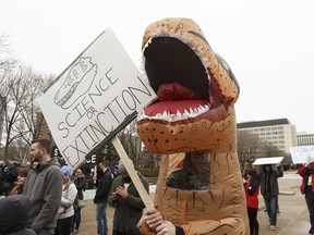 Engineer Josh Ruud wore a Tyrannosaurus Rex costume to show his support for science-based policies and thinking during the March for Science rally at the Alberta Legislature in Edmonton on Saturday, April 22, 2017.