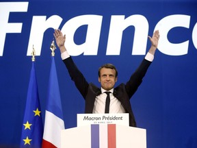 In this Sunday April 23, 2017 file photo, French centrist presidential candidate Emmanuel Macron waves before addressing his supporters at his election day headquarters in Paris.