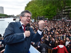 French presidential election candidate for the far-left coalition La France insoumise Jean-Luc Melenchon gives a speech aboard an "unbowed" barge, on April 17, 2017, in Paris, as part of campaign meetings along the Seine river.