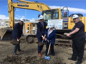 Edmonton-Centre MLA David Shepherd, left,  Mayor Don Iveson and Edmonton People in Need Shelter Society clients Jodi Sharun and Peder Kronborg break ground on a new 97-unit supportive living facility in The Quarters in Edmonton on April 4, 2017.