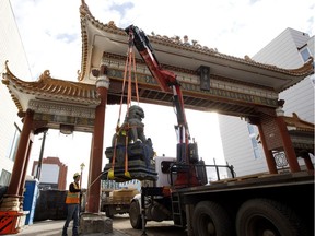 TransEd crews remove the decorative lions from the Harbin Gate, near 97 Street and 102 Avenue, in Edmonton Tuesday April 4, 2017. The lions and gate are being removed in preparation for construction of the Valley Line LRT.