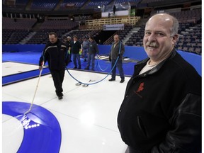 Head ice maker Jamie Bourassa, right, watches as ice crews work on the sheets for the 2013 Brier at Northlands Coliseum in Edmonton on Feb 26, 2013. (File)