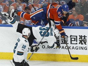 Edmonton's Zack Kassian (44) hits San Jose's Logan Couture (39) while Patrick Marleau (12) watches during the second period of a Stanley Cup playoffs game between the Edmonton Oilers and the San Jose Sharks at Rogers Place in Edmonton on Friday, April 14, 2017. Ian Kucerak / Postmedia