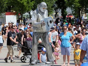 Silver Elvis (Peter Jarvis) performs during the final day of the Edmonton International Street Performers Festival in Sir Winston Churchill Square, in downtown Edmonton Alta., on Sunday July 13, 2014.