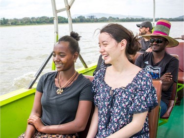 Isabel Schuppli (right) and Kidist Meskele take a boat to see hippos on the second day of the trip in Ethiopia. An interpreter sits behind them.