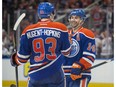 Jordan Eberle (14) of the Edmonton Oilers, celebrates his hat-trick goal with Ryan Nugent-Hopkins (93) against the Vancouver Canucks at Rogers Place in Edmonton on April 9, 2017.