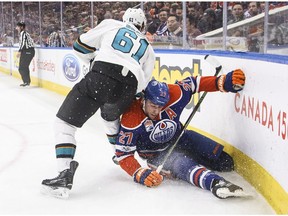 San Jose Sharks' Justin Braun (61) checks Edmonton Oilers' Milan Lucic (27) during second period NHL action in Edmonton, Alta., on Thursday, March 30, 2017. The Oilers play the Sharks in San Jose on Thursday.