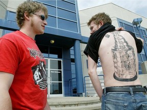 In this 2006 photo, Kevin Genest, right, displays the tattoo of the Stanley Cup and the Edmonton Oilers logo he got inked as part of a radio contest. It took nine-and-a-half hours in one sitting to complete.