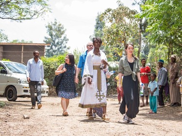 Kidist Meskele (front left) and Isabel Schuppli (right) followed by Isabel's parents walk to Kidist's home.