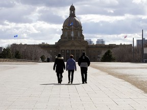 Pedestrians walk through the plaza outside the Federal Building on the Alberta Legislature grounds on Monday April 3, 2017.