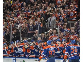 Leon Draisaitl (29) and Connor McDavid (97) of the Edmonton Oilers, celebrate McDavid's 100th point in their regular-season finale on the way to a 5-2 win over the Vancouver Canucks at Rogers Place on Sunday, April 9 2017. (Shaughn Butts)