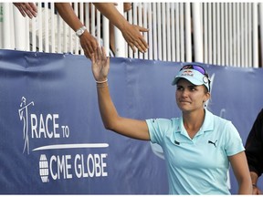 In this April 2, 2017, file photo, Lexi Thompson high fives fans as she walks to the 18th green in tears during the final round of the LPGA Tour ANA Inspiration tournament at Mission Hills Country Club in Rancho Mirage, Calif. The rules have changed on how video evidence can be applied, but it might not have changed what happened to Thompson. (AP Photo)