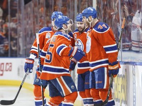 Edmonton Oilers' Mark Letestu (55), Kris Russell (4) and Zack Kassian (44) celebrate a goal against the San Jose Sharks during second period NHL playoff action in Edmonton, Alta., on Friday April 14, 2017.