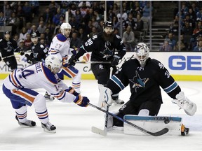 San Jose Sharks goalie Martin Jones (31) stops a shot from Edmonton Oilers' Jordan Eberle, left, during the first period of an NHL hockey game Thursday, April 6, 2017, in San Jose, Calif.