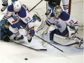 San Jose Sharks right wing Melker Karlsson (68) and Edmonton Oilers center Ryan Nugent-Hopkins (93) battle for the puck in front of goalie Cam Talbot (33) during the third period in Game 6 of a first-round NHL hockey playoff series Saturday, April 22, 2017, in San Jose, Calif. The Oilers won 3-1.