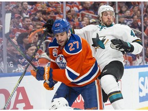 Milan Lucic of the Edmonton Oilers hits Brenden Dillon of the San Jose Sharks in Game 2 of their first-round playoff series at Rogers Place in Edmonton on April 14, 2017. (Shaughn Butts)