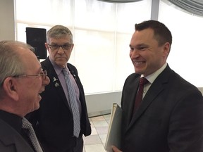 Minister Deron Bilous (right) speaks with Village of Warburg Mayor Ralph Van Assen as Capital Region Board chair Nolan Crouse looks on. Bilous announced funding for a regional economic development corporation Thursday.