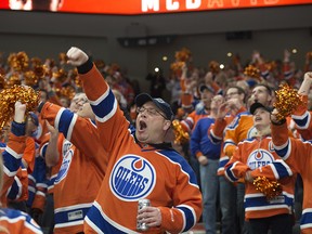 Fans of the Edmonton Oilers celebrate a third period goal against  San Jose Sharks in Game Two of the NHL first round playoffs at Rogers Place in Edmonton on April 14,  2017. Photo by Shaughn Butts / Postmedia