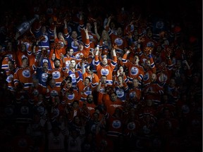 Anthem singer Robert Clark stands among the crowd at Rogers Place while singing the national anthem before Game 2 of the Edmonton Oilers' playoff series against the San Jose Sharks on April 14, 2017.