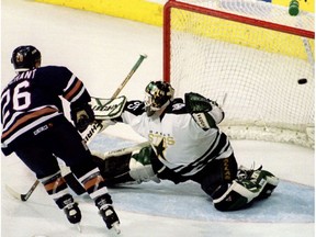 Edmonton Oilers forward Todd Marchant scores the fourth and winning goal for his team as Dallas Stars goaltender Andy Moog tries to block the puck, April 29, 1997.