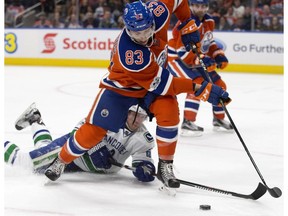 The Edmonton Oilers' Matthew Benning battles the Vancouver Canucks' Markus Granlund at Rogers Place in Edmonton on March 18, 2017. (David Bloom)