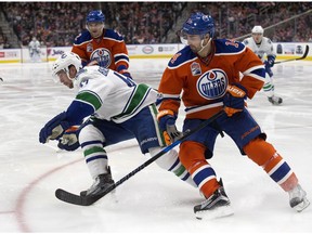 The Edmonton Oilers' Jordan Eberle (14) battles the Vancouver Canucks' Sven Baertschi (47) at Rogers Place, in Edmonton on March 18, 2017. David Bloom)