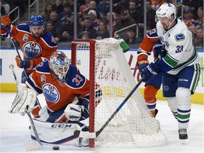 Edmonton Oilers goalie Cam Talbot makes a save against the Vancouver Canucks' Henrik Sedin at Rogers Place in Edmonton on March 18, 2017. The Oilers won 2-0. (David Bloom)