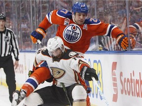Anaheim Ducks forward Patrick Eaves is checked by Edmonton Oilers forward Milan Lucic during NHL action in Edmonton on April 1, 2017.